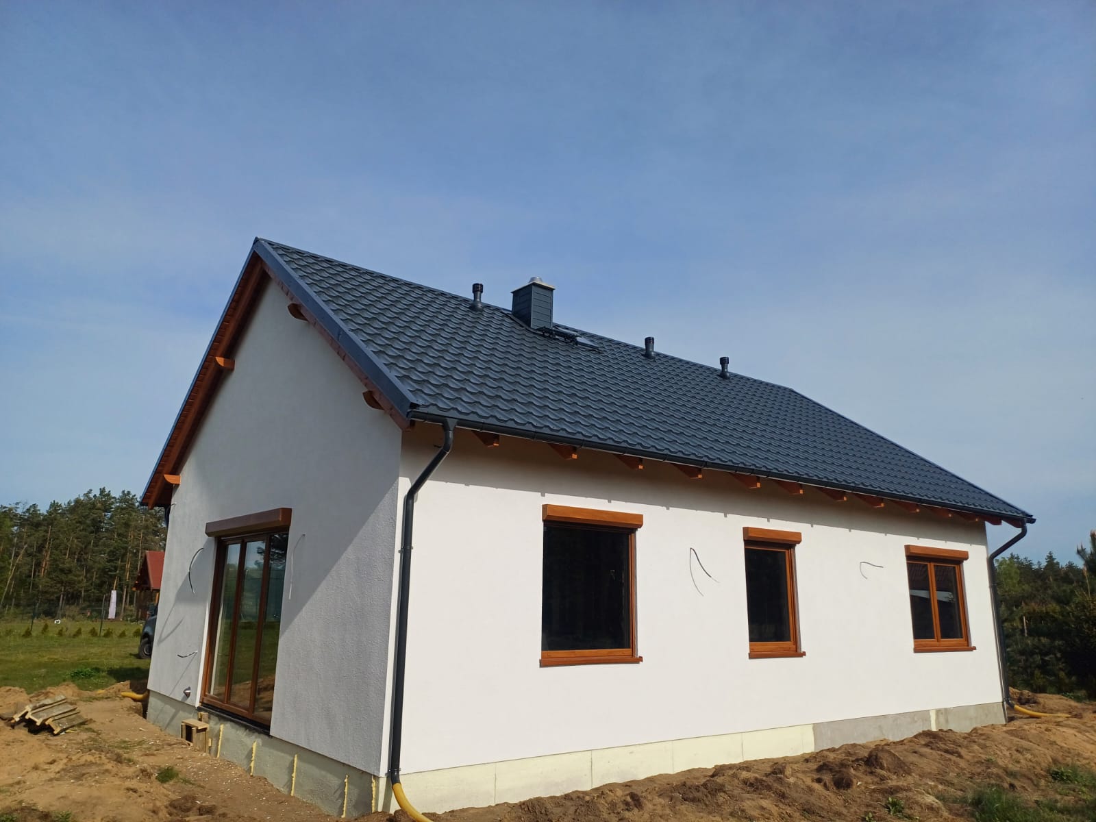 Dom szkieletowy — elewacja tynk biała, dach grafitowy