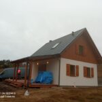 Dom szkieletowy — elewacja biała z drewnem, grafitowy dach